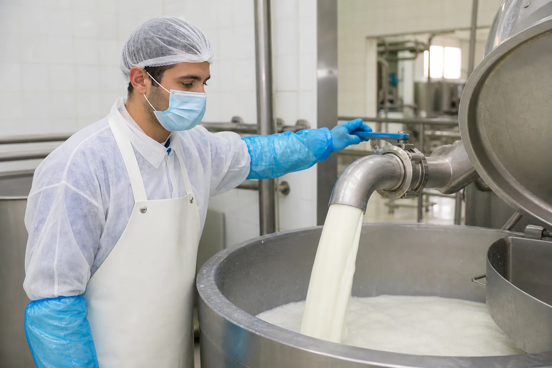 Technician receiving raw milk in a hygienic bay