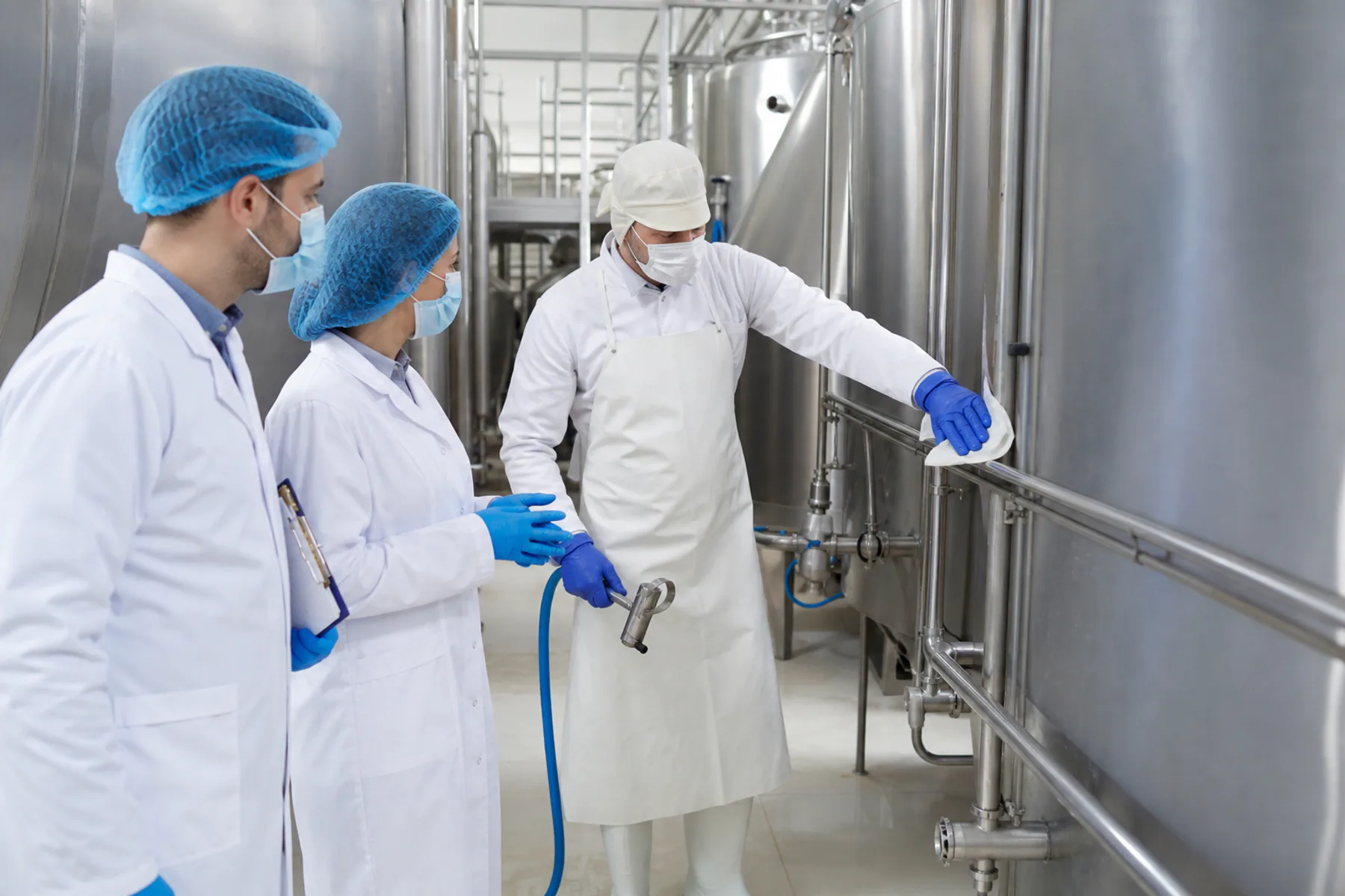 Reviewing a sanitation procedure beside clean dairy equipment