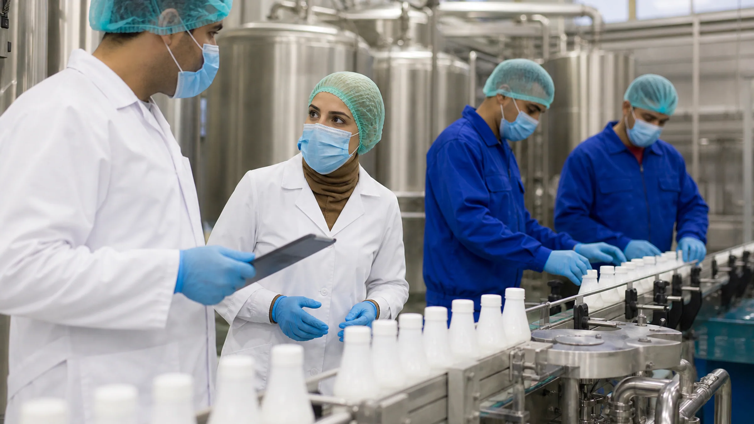 Quality and operations staff inside a modern dairy plant