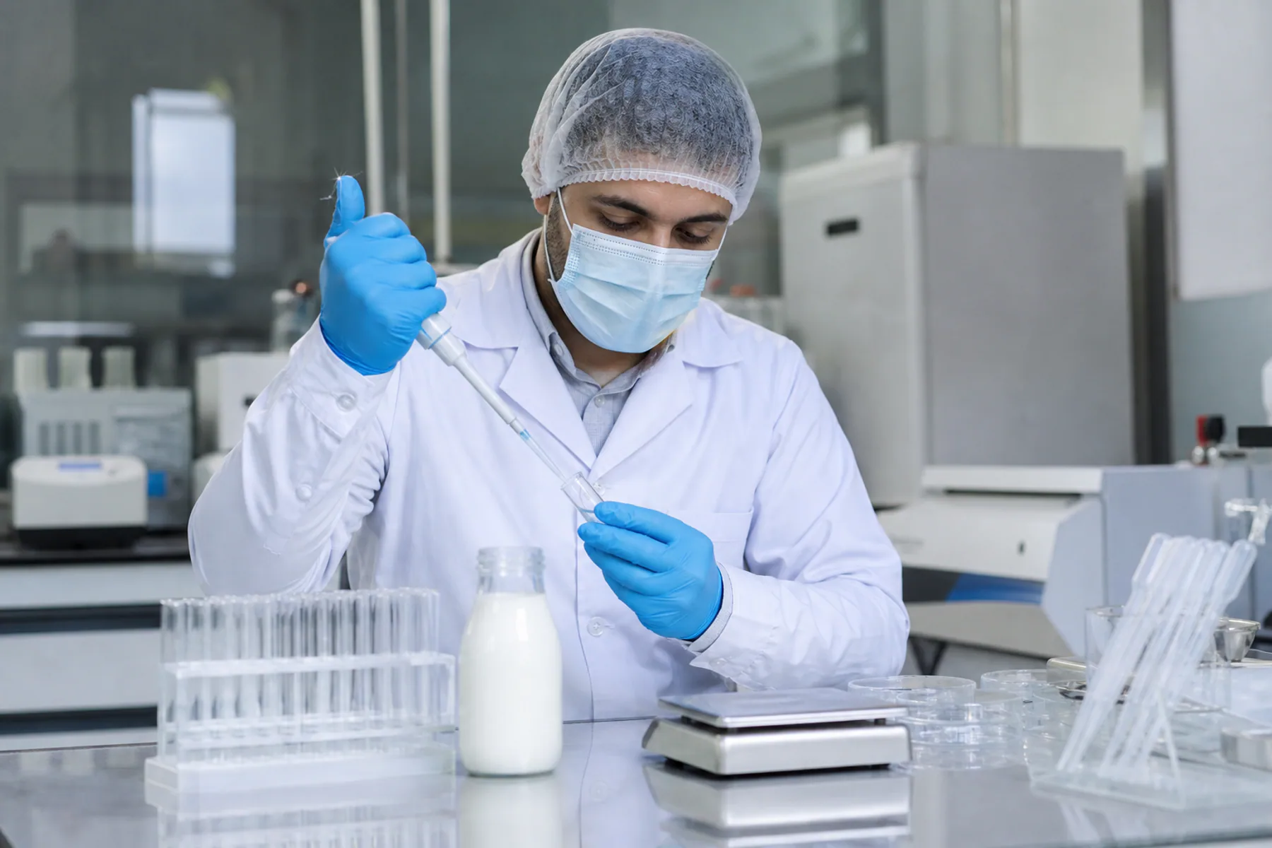Laboratory technician preparing a milk sample for testing